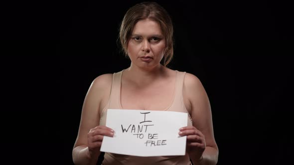 Hoping Plus Size Woman Raising I Want to Be Free Poster Looking at Camera alt