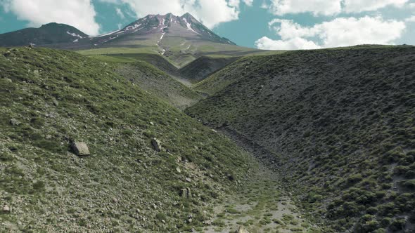 Drone Flies to Mountain Over the Surface