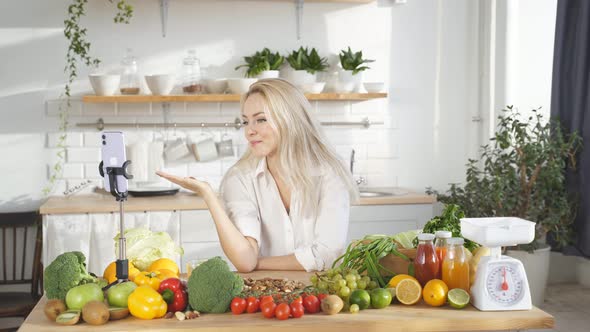 Female Food Blogger Tells the Camera What you Can Cook in the Kitchen with Fresh Vegetables