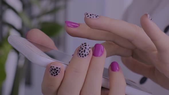 Manicured Female Hands with Stylish Pink Nails Holding Mobile Phone alt