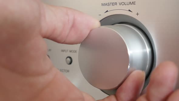 Setting volume up on silver modern audio amplifier jog dial 4K 2160p UltraHD footage - Higher volume alt