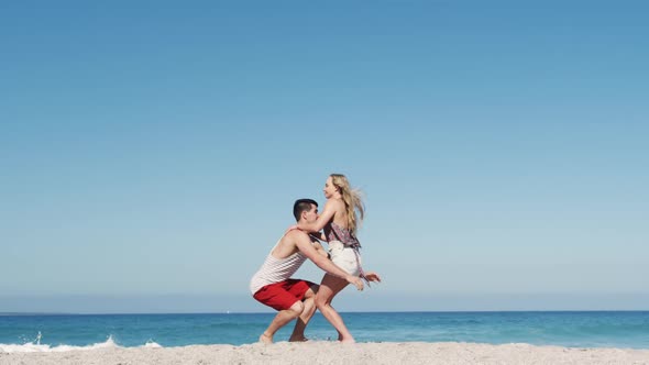 Couple in love enjoying free time on the beach together alt