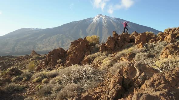 Young Woman Arms Outstretched Observes a Huge Crater of Teide Volcano, Tenerife, Canary Islands alt