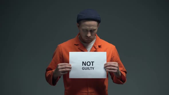 Caucasian Prisoner Holding Not Guilty Sign, Asking for Justice, Human Rights alt
