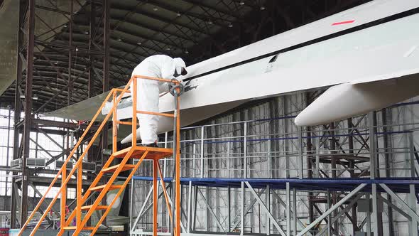Repair of An Aircraft Wing. Painting the Wing of The Aircraft in White alt