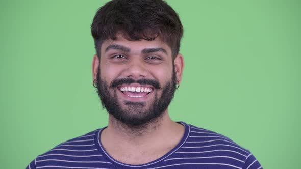 Face of Happy Young Overweight Bearded Indian Man Smiling alt