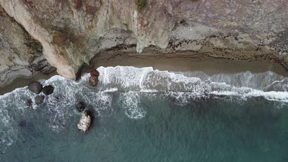 Aerial View From Above on Calm Azure Sea and Volcanic Rocky Shores alt