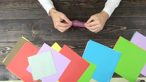 Man Making Pink Paper Crane alt