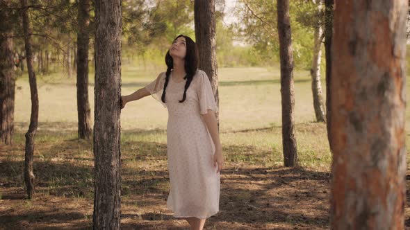 Happy Woman in Forest Enjoying Nature. Cute Young Girl Walking Outdoors alt