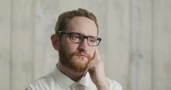 Portrait of Handsome Pensive Man with Beard Wearing Glasses