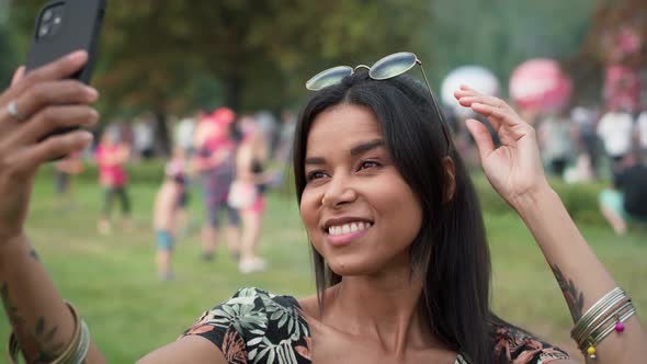 Woman meet friends and making selfie at music festival. Shot with RED helium camera in 8K. alt