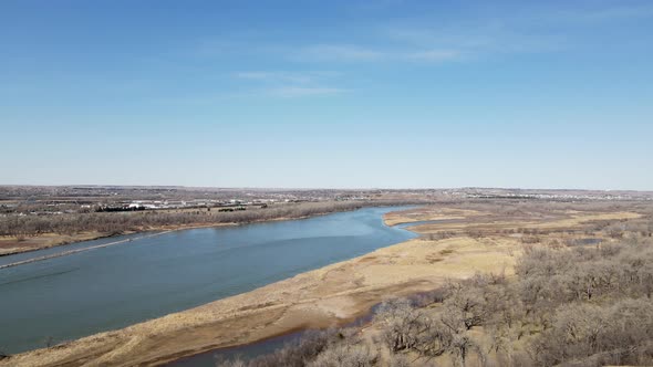 Aerial view over river with water creeping through the islands. Wispy clouds in sky.