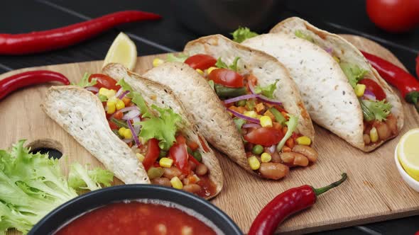 The Mexican Dish of Tako Corn Flat Cake with Vegetable Filling on a Wooden Board alt