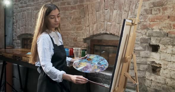 Talented Innovative Pretty Female Artist Draws with Brush on the Canvas. Contemporary Young Woman