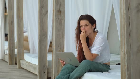Serious Young Woman With Laptop Thinking About Something alt