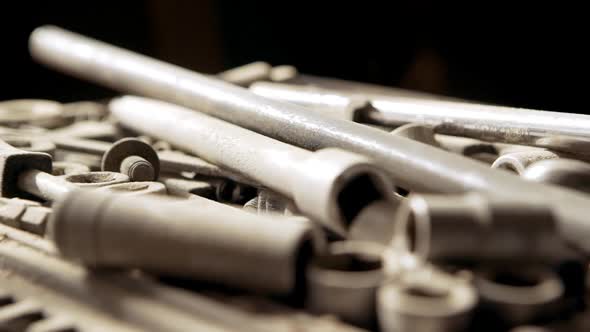 Set of Socket Wrenchs Lying Covered with Wooden Sawdust in Joinery alt