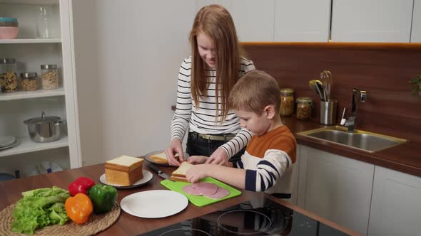 Adorable Deaf Kids Making Sandwiches in Kitchen alt