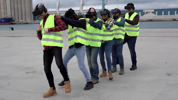 Dockworkers having fun using 3d virtual reality goggles