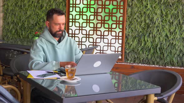 Man Sitting at His Working Place in Cafe