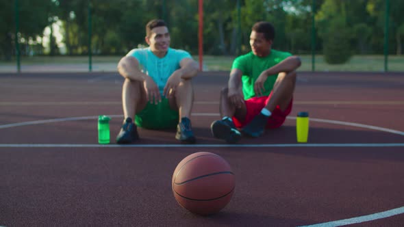 Basketball Players Enjoying Leisure After Match alt