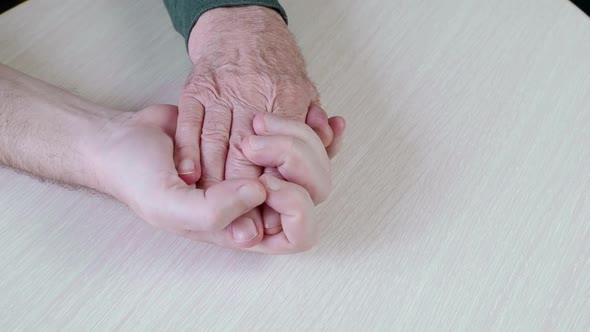 Closeup of an Older Man Holding the Hand
