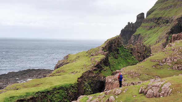 Aerial Back View of Huge Cliffs in Faroe Islands Green Rocky Mountainpowerful Ocean Wavesin a Cloudy alt