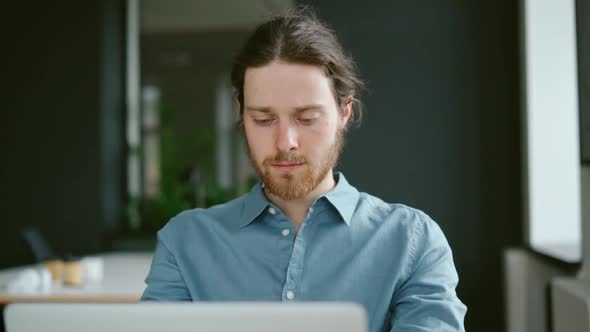 Young Focused Man Freelancer Working on Laptop Computer Remotely