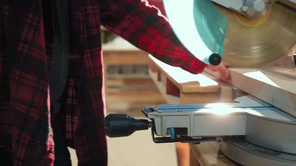Carpenter at work in woodshop alt