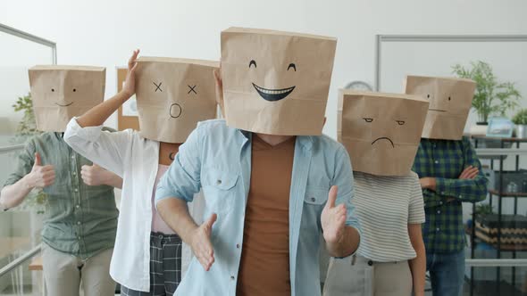 Slow Motion Portrait of Funny Office Workers Wearing Paper Bags with Emoji Pictures Expressing alt
