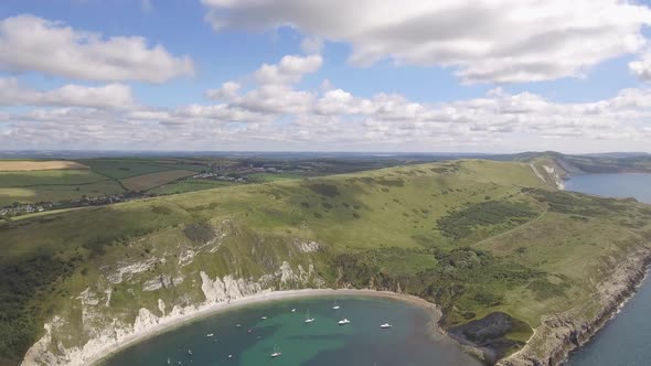 Cornwall aerial drone view of seaside rocky cliffs and turquoise water