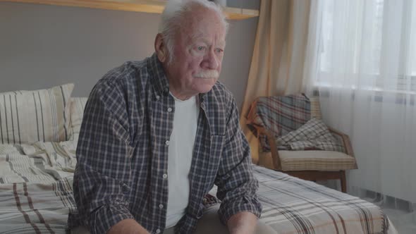 Senior Man Watching TV in Bedroom alt