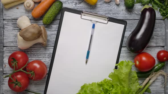 Pen Rolling on Page with Recipe on Kitchen Counter. Easy To Place Your Reciepe on a Blank Paper. alt