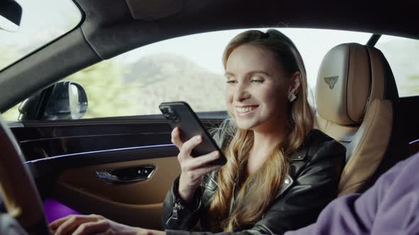 The driver drives the car, and the passenger takes photos of the driver.