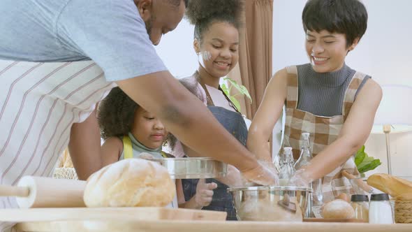 African America family wearing apron thresh flour for cooking bakery or bread together. alt