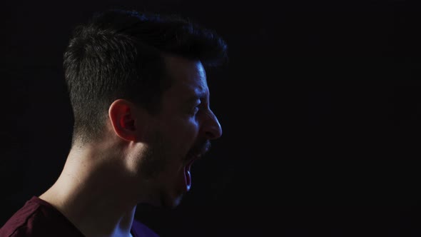 Side view of a man yelling alt