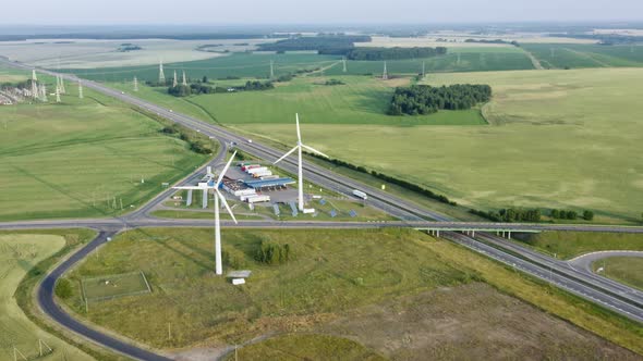 Aerial View Windmills Wind Turbines Producing Clean Ecological Electricity By Road in Green alt