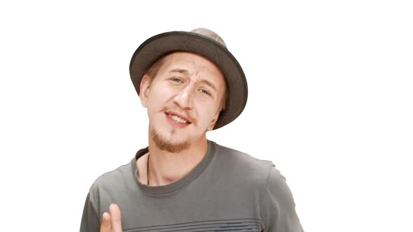 Young Handsome Man in Hat Smiling Singing Dancing Over White Background alt