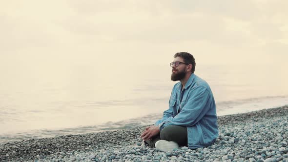 Happy Man Sitting on Beach alt