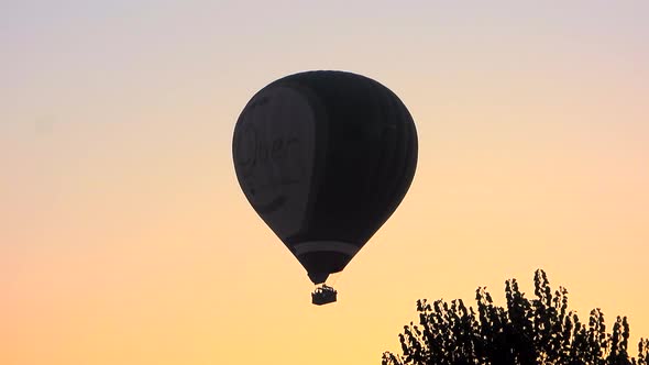 Hot Air Balloon Flying in Morning Sunrise Sky