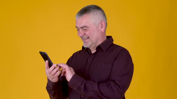 Handsome adult man uses smartphone texting messages in social media alt