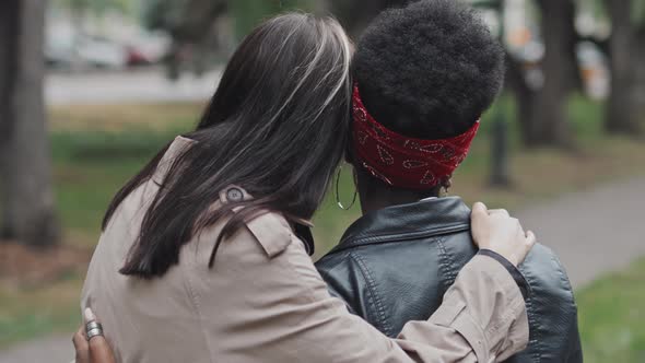 Lesbian Couple Hugging in Park alt