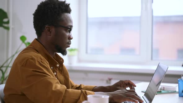 Businessman Working with Laptop and Typing While Sitting at Table in Home Office Spbas alt