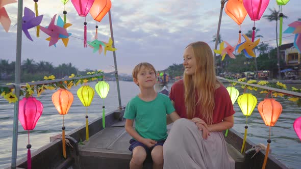 A Young Woman and Her Son Tourists Visit an Ancient Town of Hoi An in the Central Part of Vietnam alt
