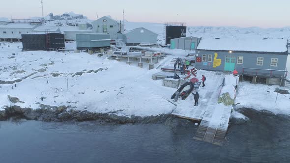 People Work on Pier of Antarctic Polar Station - Vernadsky. View of Robotic Arm alt
