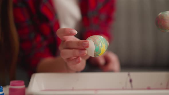 Art Teacher and Little Student Apply Pattern on Boiled Eggs alt