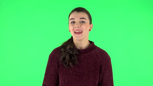 Lovely Girl Smiles Broadly and Winks. Green Screen alt