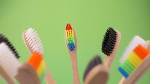 Colorful Professional Soft Toothbrushes with Lot of Bristles in Straight Cut on Green Background