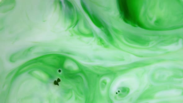 Ink in Water, Green Ink Reacting in Water Creating Abstract Background