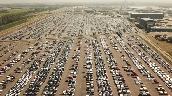 Many new and occasion Cars on a huge parking lot waiting for shipment, Aerial alt