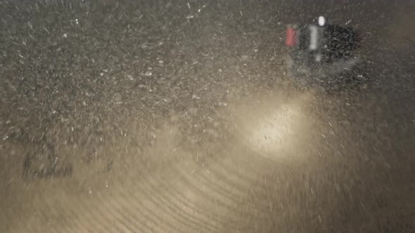 The Drummer Hits the Wet Drum Cymbal with His Drumstick and the Water Splashes in Slow Motion alt